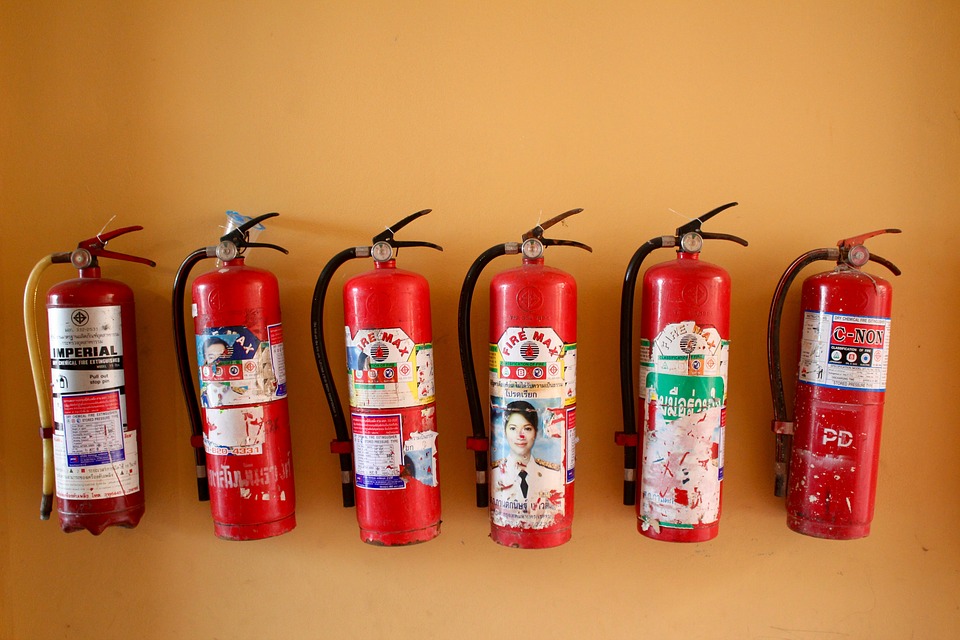 Fire extinguishers lined up on a wall